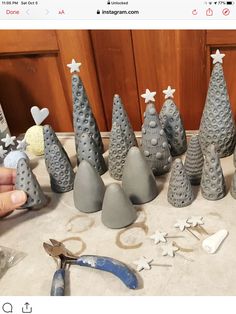 someone is making christmas trees out of clay and other items that are on the counter