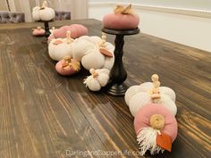 some pumpkins are sitting on top of a wooden table