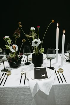 the table is set with flowers and candles