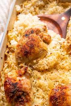 chicken and rice in a baking dish with a wooden spatula on the side, ready to be eaten