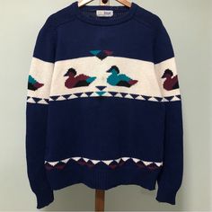 Vintage 90s Pringle Of Scotland Navy Blue Striped Chunky Knit Knitted Pullover Graphic Grandpa Crewneck Sweater. A White Stripe Going Across The Chest And Sleeves With Multicolored Magenta, Black, And Teal Ducks. With Geometric, Upside Down Triangles. There’s A Small Stain On The Front And On The Sleeve. Made In The Northern Mariana Islands (Usa). 100% Cotton. Size Large. Measurements Armpit To Armpit: 23” Length: 27.5” No Trades Grunge Skater Earthy Preppy Academia Streetwear Alt Cute Grandpa Sweater, Academia Streetwear, Colorful Grandpa Sweater, Blue Retro Sweater With Graphic Print, Duck Sweater, Preppy Academia, Vintage Blue Crew Neck Sweater, Grunge Skater, Teal Duck