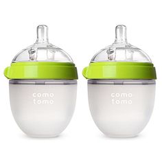 two baby bottles sitting side by side, one with a green lid and the other with a white top