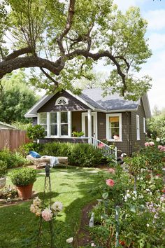 a house that is in the middle of some flowers and grass with words on it