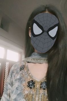 a woman with long black hair wearing a spiderman mask on her face and the back of her head