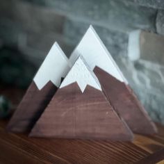 two wooden mountains sitting on top of a table