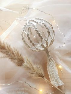 a decorative glass ornament sitting on top of a white cloth