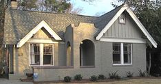 a gray house with white trim and windows