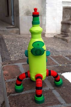 a green and red fire hydrant sitting on top of a sidewalk