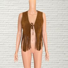 Vintage 60s - 70's Tan Beaded Suede Fringe Vest Boho Western style cropped length vest  tan brown suede leather fabric  Gold beaded trim  front tie closure  Brand: Mr Leather good condition, some general wear as pictured Measurements: Length: 22" Pit to pit: 18" Festival Fringe Brown Vest, Brown Fringe Vest For Festival, Hippie Style Vest For Fall Festival, Hippie Style Fitted Sleeveless Vest, Sleeveless Brown Vest For Festivals, Fitted Sleeveless Hippie Vest, Western Style Brown Vest For Fall, Western Brown Vest For Fall, Brown Western Vest For Fall