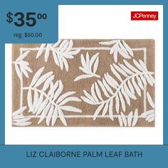 a bath mat with white leaves on it and the price $ 35 00 is $ 50 00