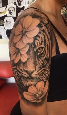 a woman's arm with a tiger and flowers on it