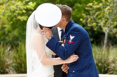 the bride and groom are kissing each other