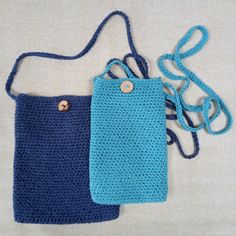 two crocheted purses sitting next to each other