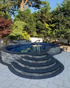 an outdoor swimming pool with steps leading up to it