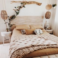 a bed with pillows and blankets on top of it