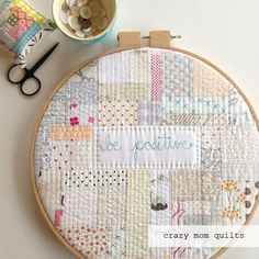 a cross stitch pattern with the words be positive on it next to scissors and yarn