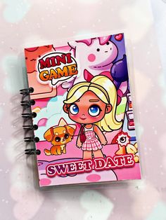 a notebook with a cartoon character on the front and pink cover, sitting on top of a table