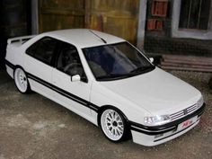 a white car parked in front of a garage