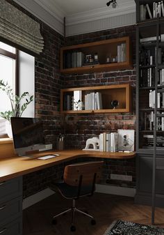 a computer desk sitting under a window next to a bookshelf