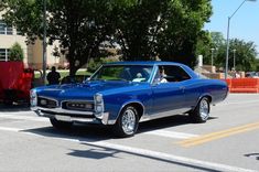 a blue car is parked on the street