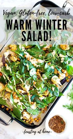 an image of warm winter salad in a pan with herbs and seasoning on the side