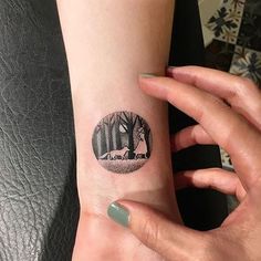 a woman's arm with a tree tattoo on it