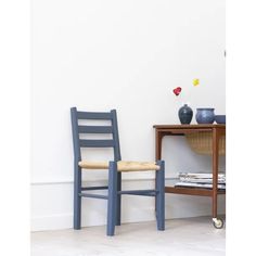 a blue chair sitting next to a wooden table