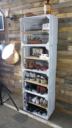 a shelf with several pairs of shoes on it in front of a wall mounted camera