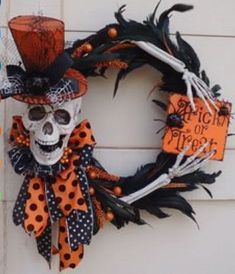 a halloween wreath with a skeleton wearing a top hat and polka dot bow tie on the front door