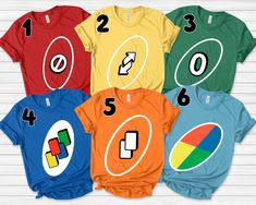 six t - shirts with numbers and symbols on them, all in different colors to choose from