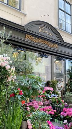 a flower shop with lots of flowers in front of it