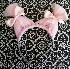 two pink bows are on top of a headband