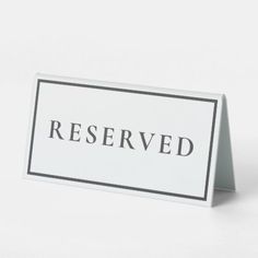 a white and black reserved sign on a white background with the word reserved printed on it