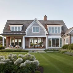 a large house with lots of windows in the front yard