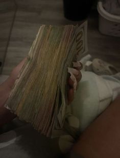 a person is holding money in their hand