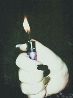 a person holding a lighter in their hand