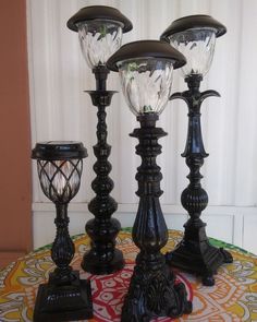 three black lamps sitting on top of a table