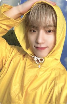 a young man wearing a yellow rain coat