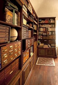 a room with many bookshelves and drawers