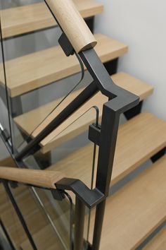 a set of wooden stairs with metal handrails