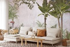 the living room is decorated with tropical wallpaper