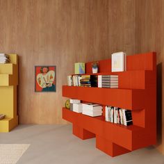 an orange book shelf with books and magazines on it in a modern living room setting