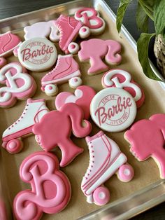 pink and white decorated cookies in a box