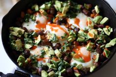 eggs and avocado are in a skillet