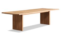 a long wooden table sitting on top of a white floor