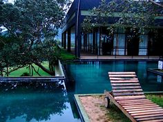 an empty swimming pool in front of a house