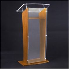 a wooden podium with clear glass panels on it's sides and a black background