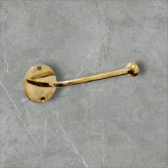 a gold handle on a gray wall with a black and white marble floor in the background