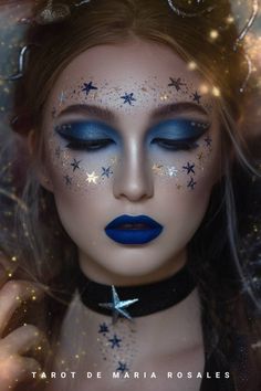 a woman with blue makeup and stars on her face