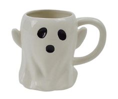 a white coffee mug with black eyes and a ghost face